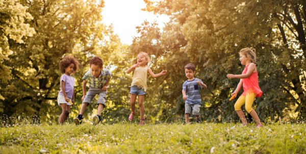 A group of children playing in the grass.